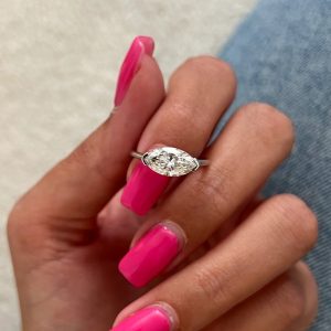 East-west marquise solitaire engagement ring with plain slim band.