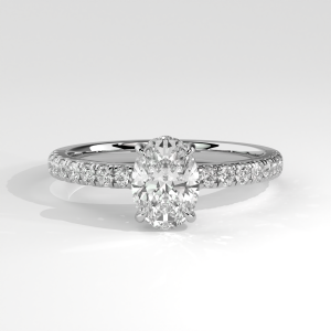 Oval solitaire engagement ring with pavé diamond band and four-prong basket setting