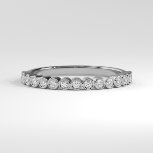 Narrow eternity band with bezel-set round diamonds encircling the ring